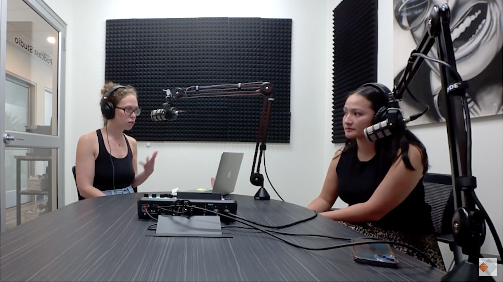 two people recording in a sound booth